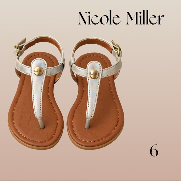 Nicole Miller Other - Nicole Miller Silver iridescent T-strap Sandals with gold buckle and logo 6 NWOT